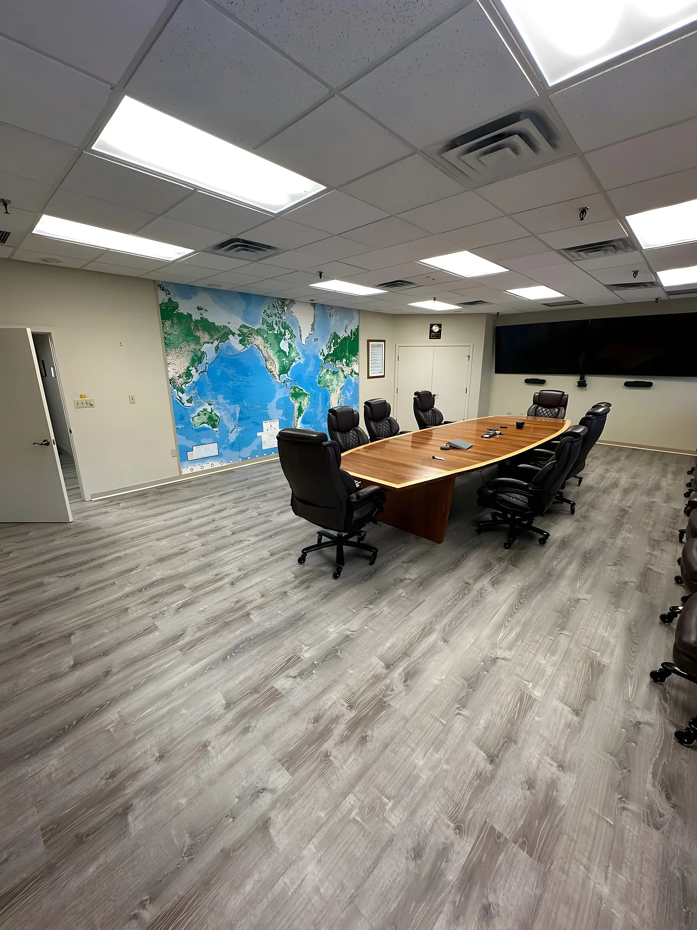 Commercial conference room with gray vinyl plank flooring