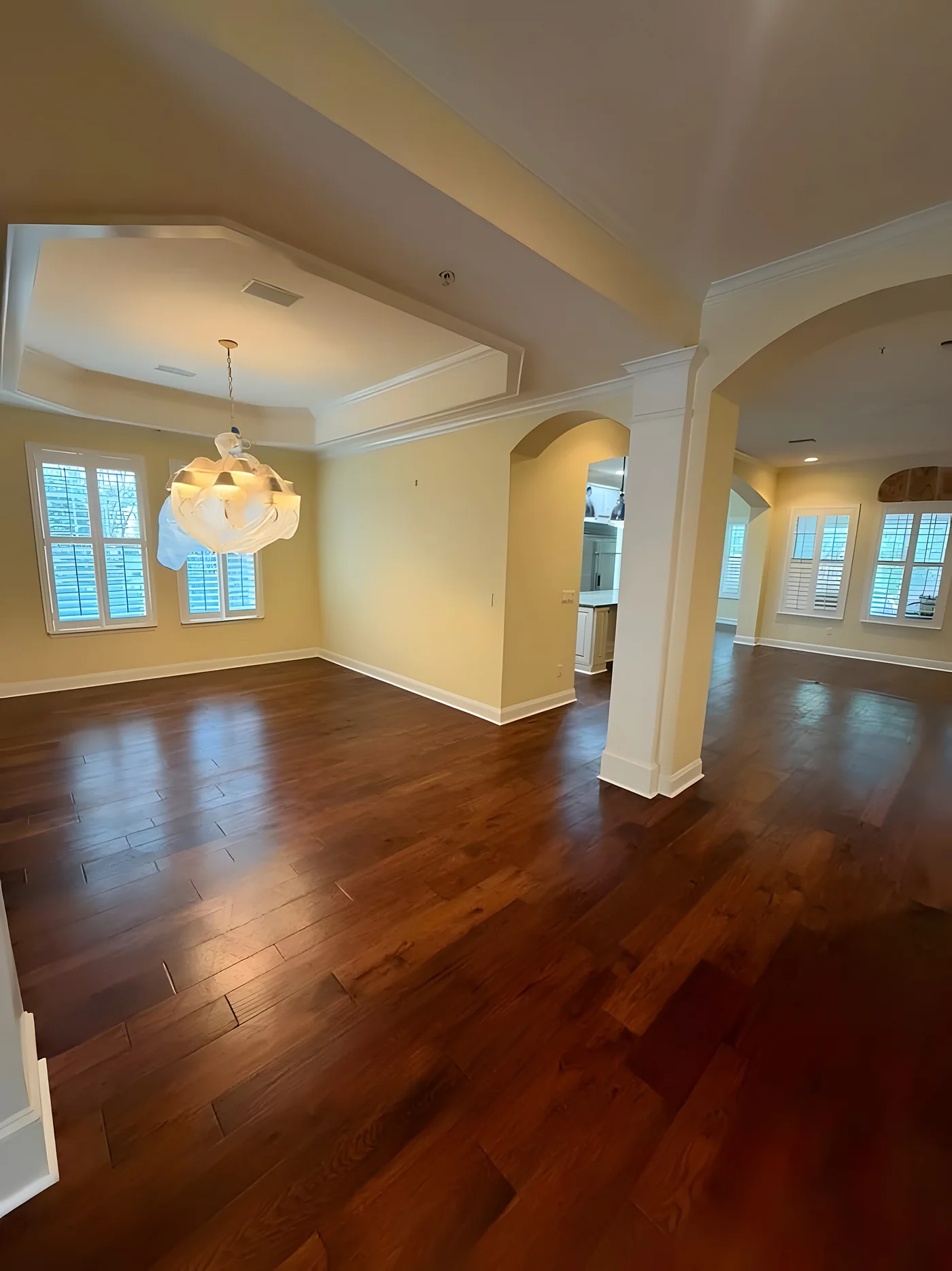 Hardwood floors in a formal dining room with arches